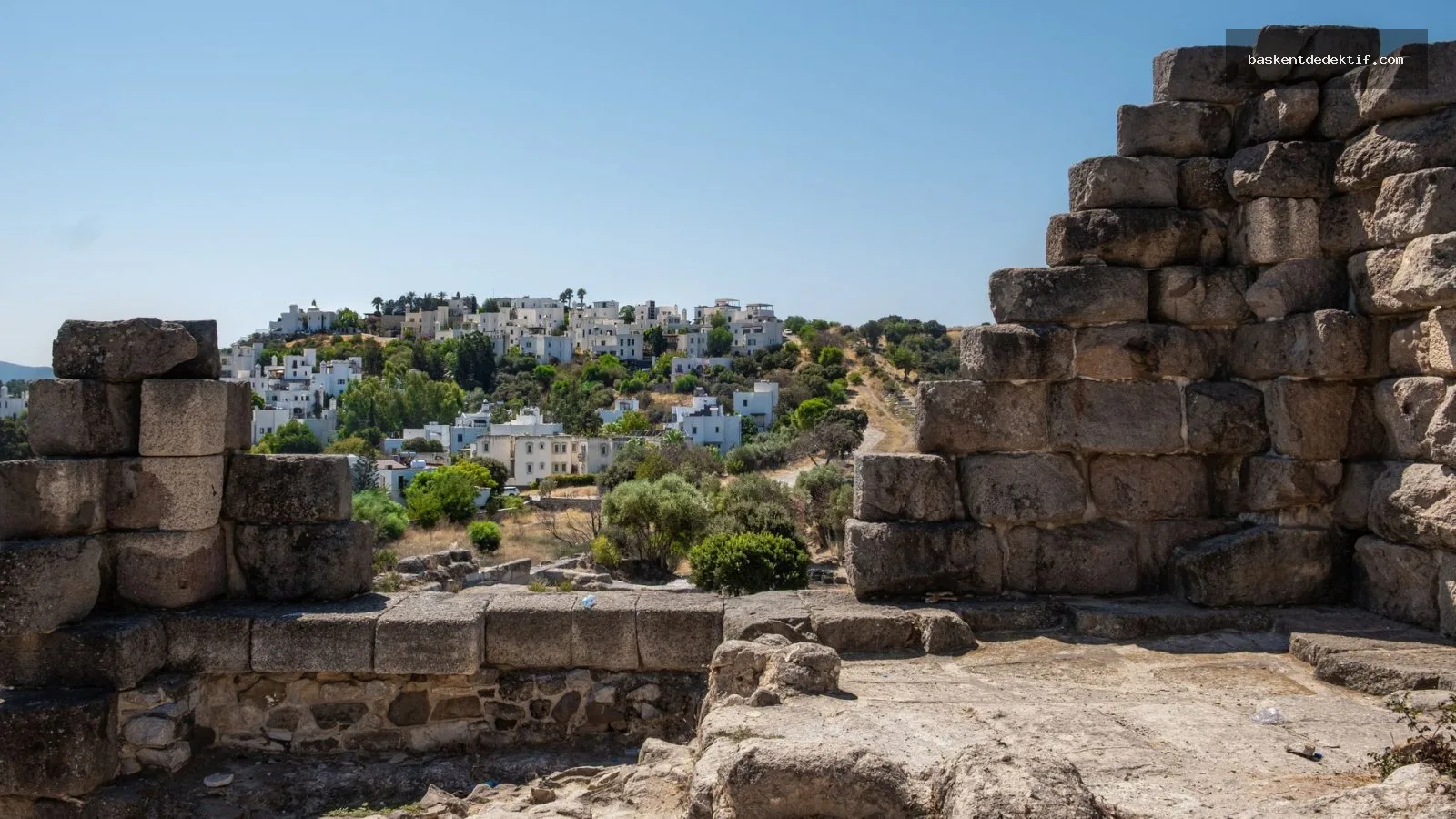 Bodrum’un tarihi duvarları ve tepede beyaz evler arasında görüntülenmiş eski kalıntılar