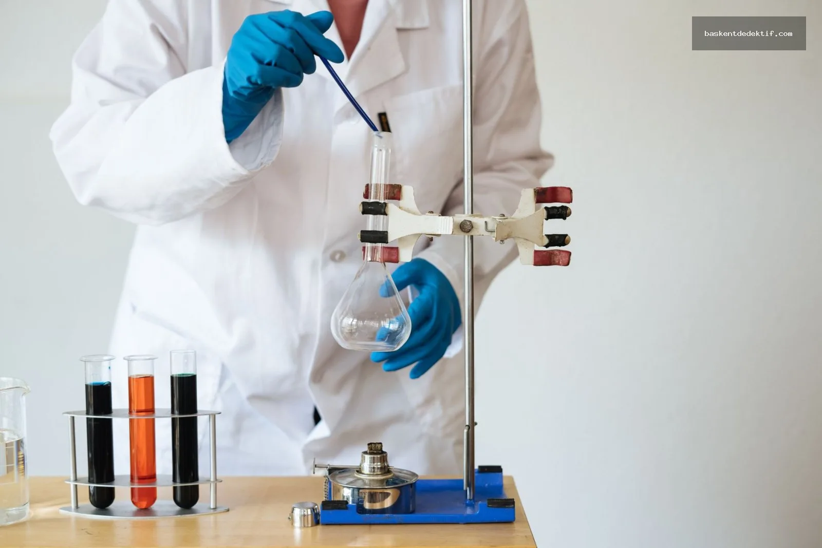 Laboratory scientist pipetting into flask with focus on meticulous research process